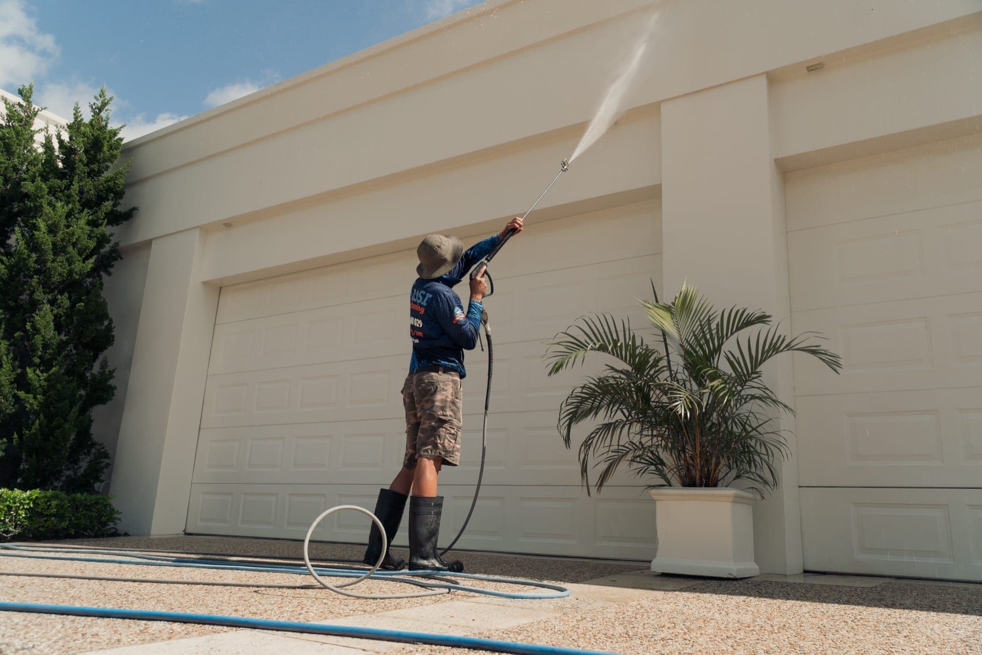 Pressure washing a concrete driveway with a rotary surface cleaner in Brisbane