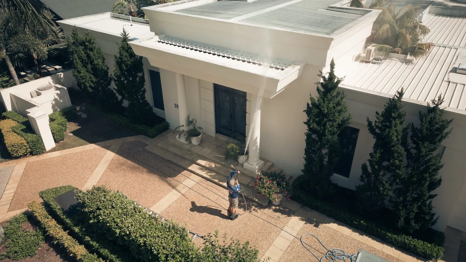 Aerial view of a soft-washed Brisbane home showing clean rendered walls